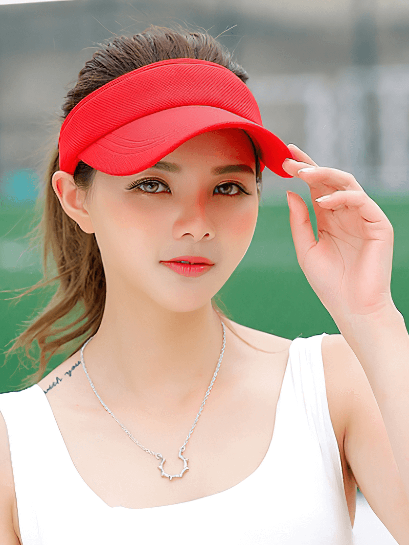 Woman wearing a red Tennis Golf Breathable UV Protection Adjustable Visor Cap, perfect for sports and outdoor activities.